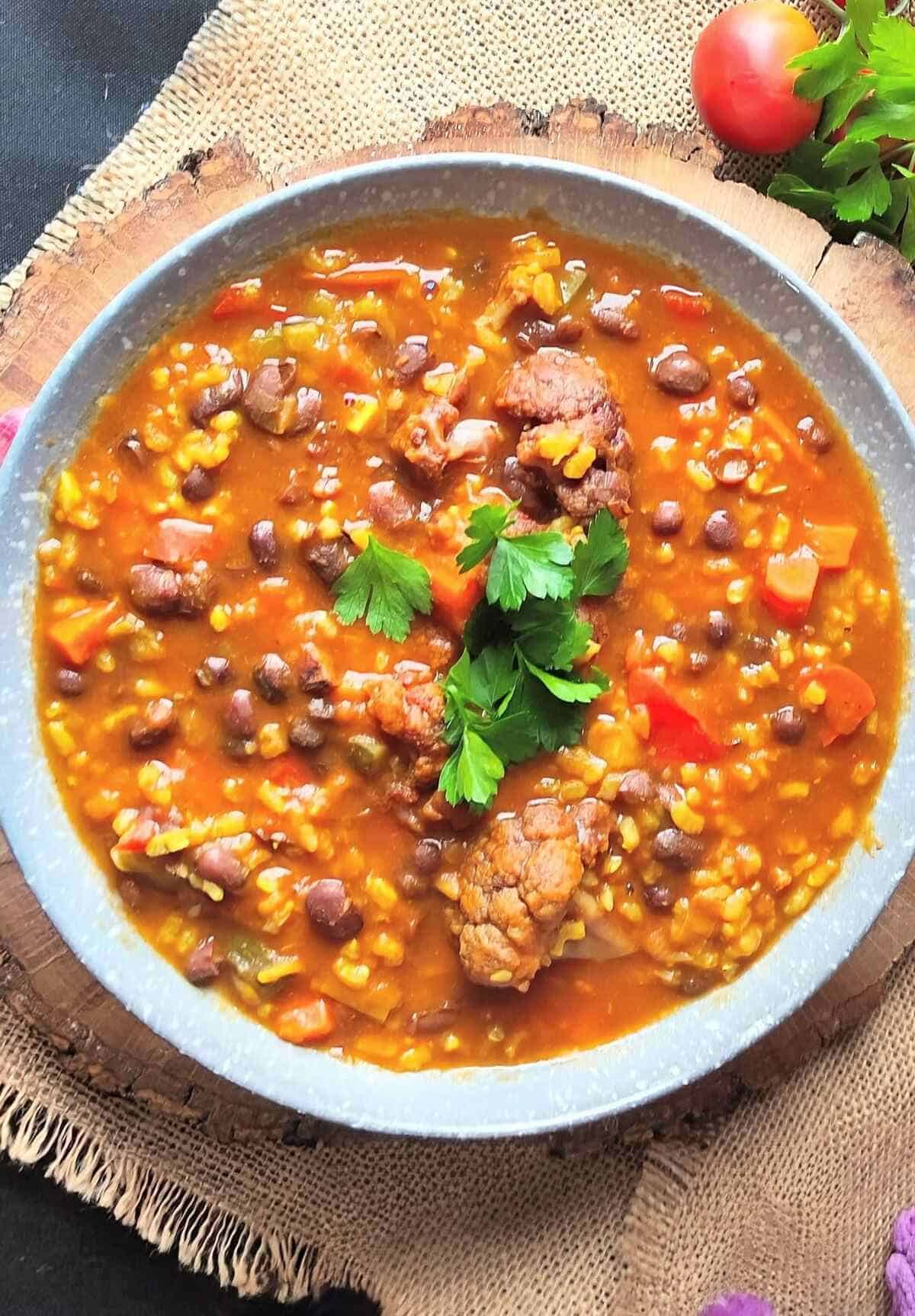 A bowl of adzuki bean and brown rice stew with vegetables.