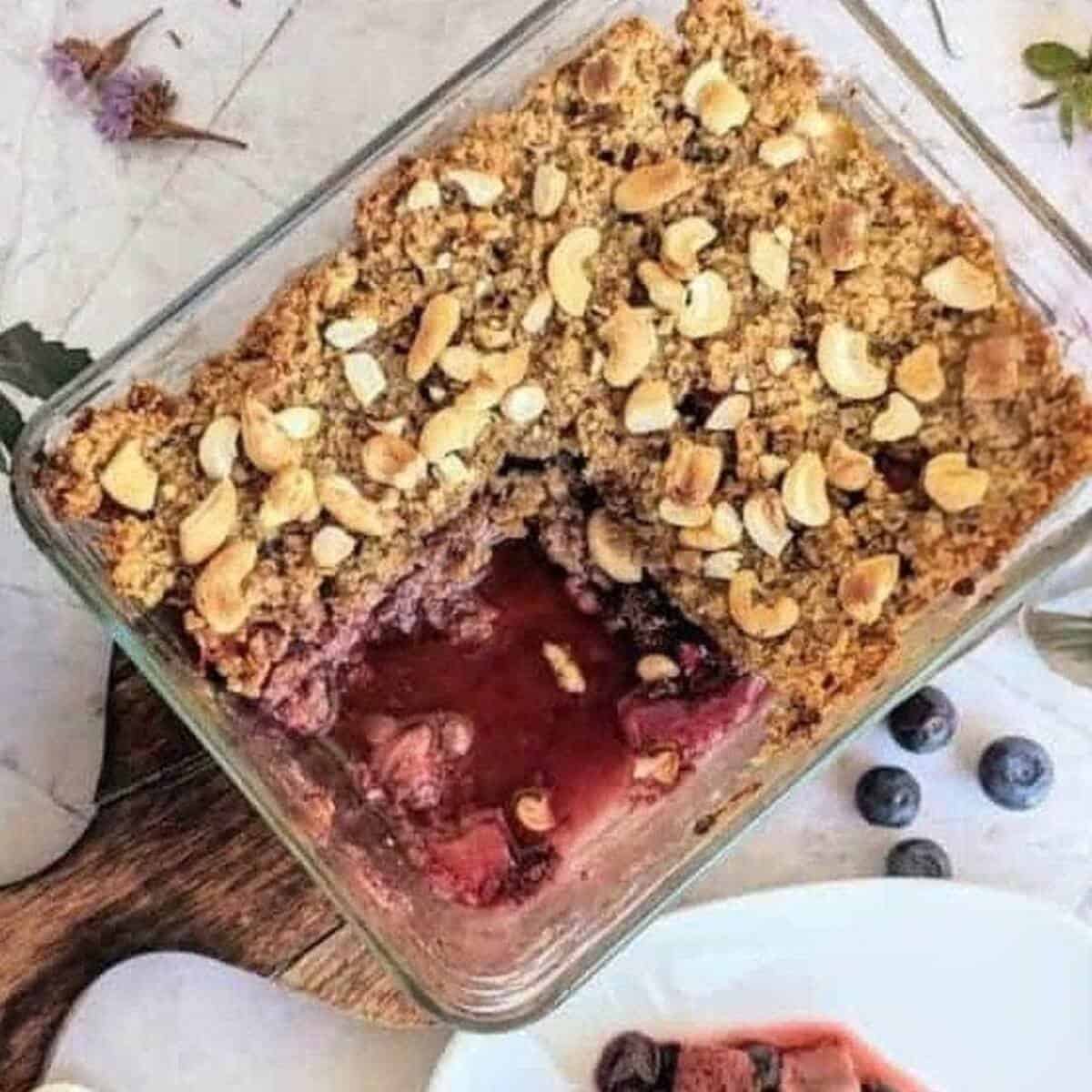 A dessert with berries and a nut oat crumble.
