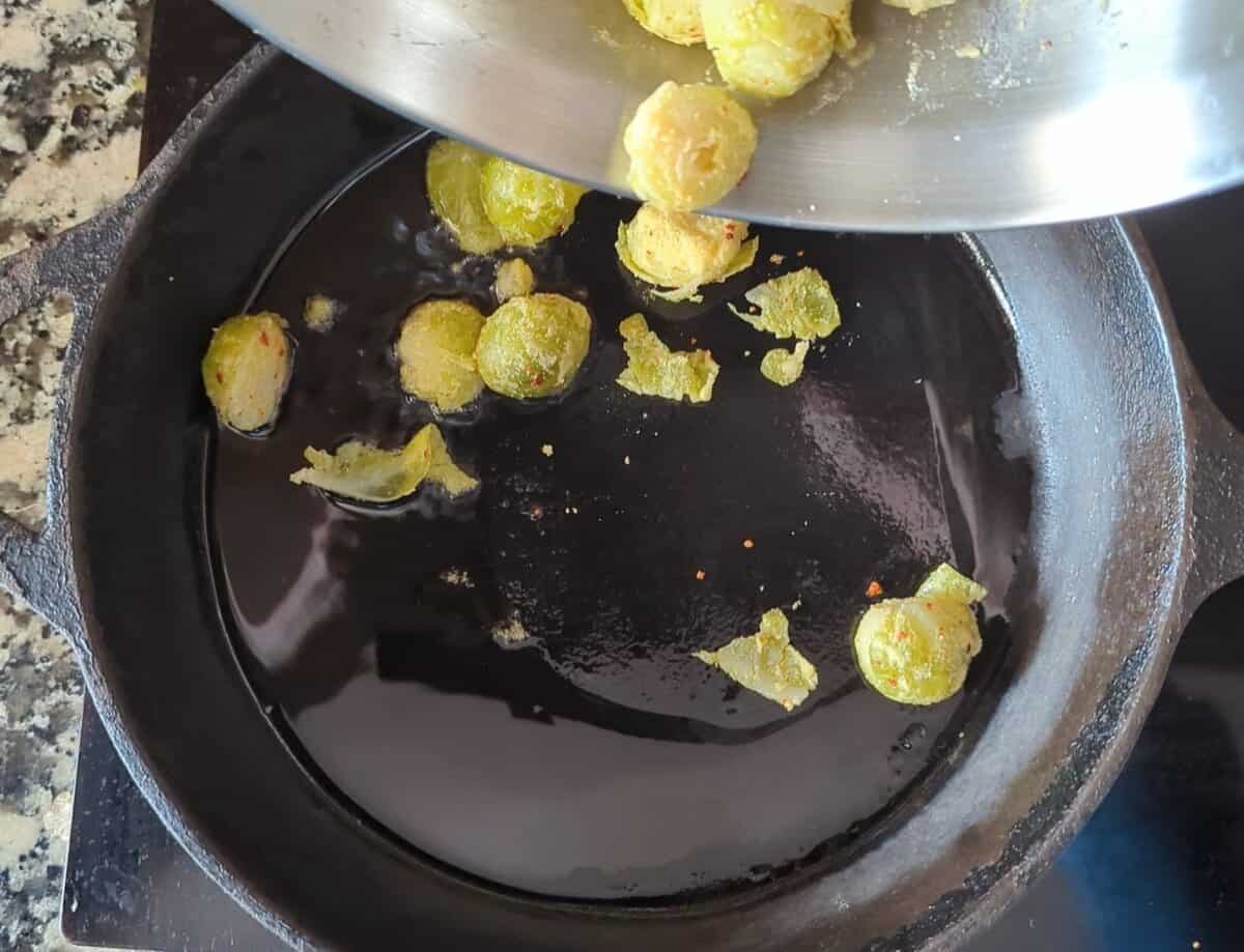 Brussels sprouts being cooked in a skillet.