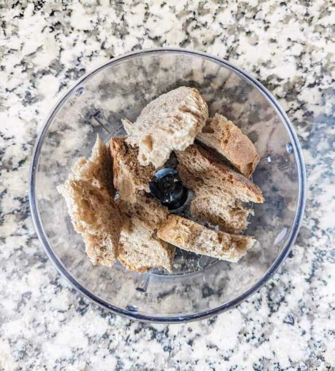 Wholemeal bread in a food processor to convert into crumbs.