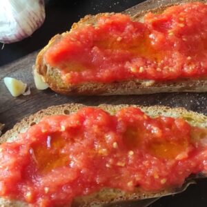 Vegan tomato garlic bruschetta on toasted bread with fresh garlic and herbs. Perfect appetizer or snack.