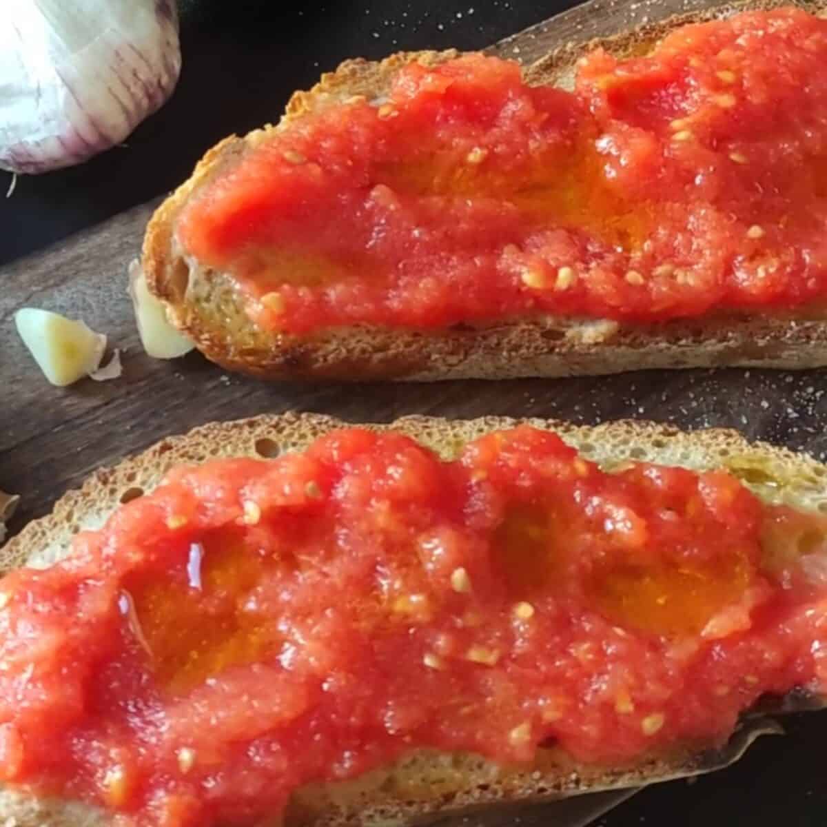 Vegan tomato garlic bruschetta on toasted bread with fresh garlic and herbs. Perfect appetizer or snack.