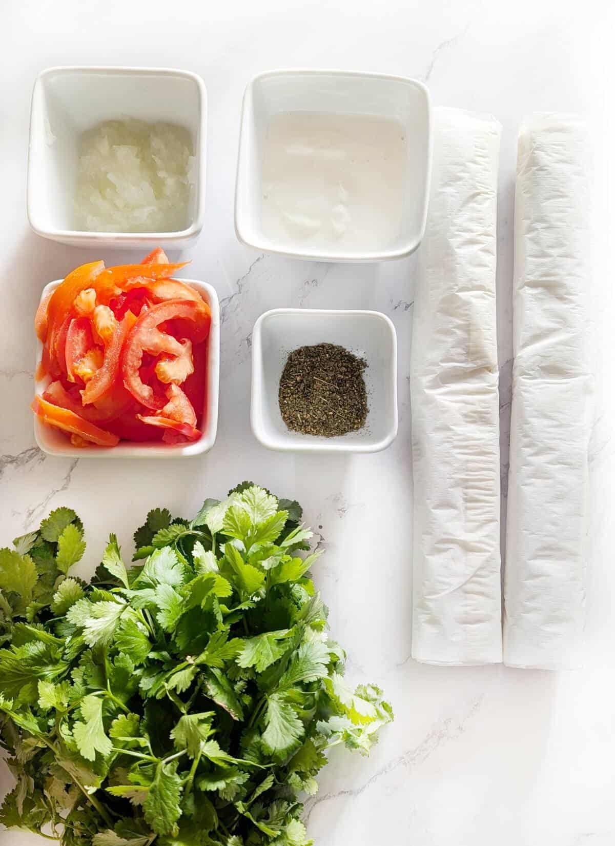 Puff pastry tomato rose ingrdients on a marble surface.