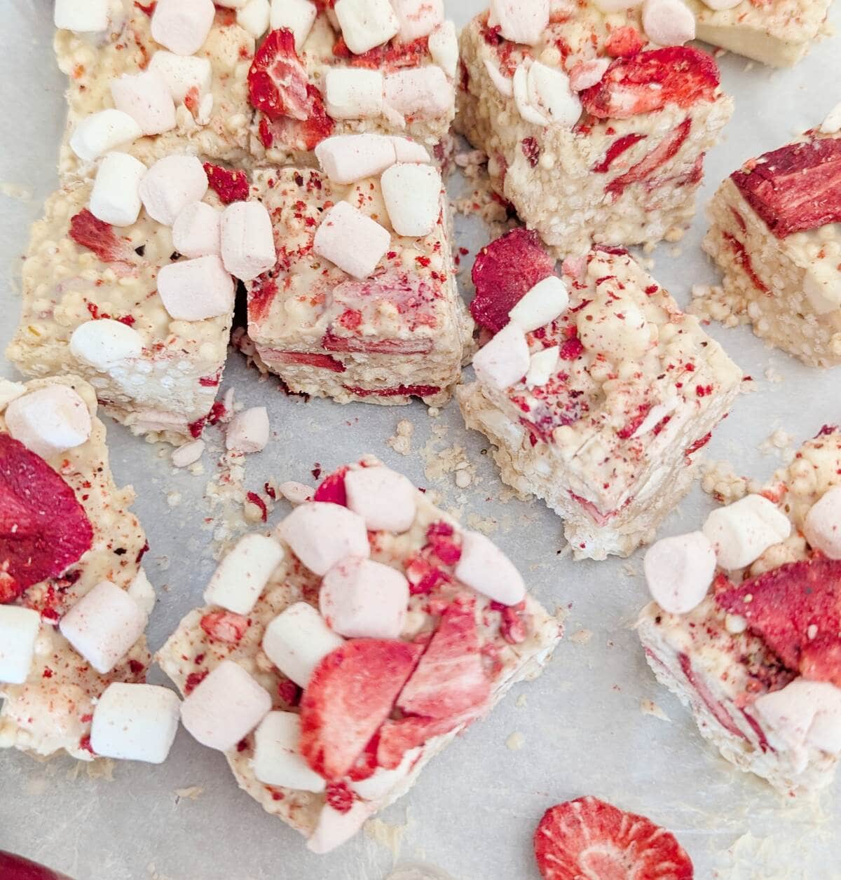 Chopped up chunks of quinoa bites on a white marble surface.