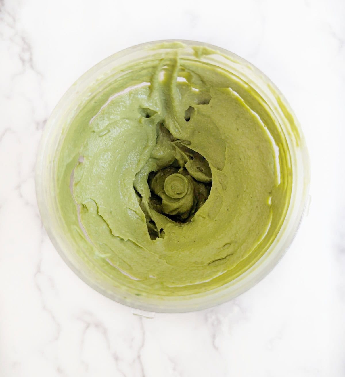 Spinach and pistachio hummus ingredients in a blended into a smooth creamy vegan dip.
