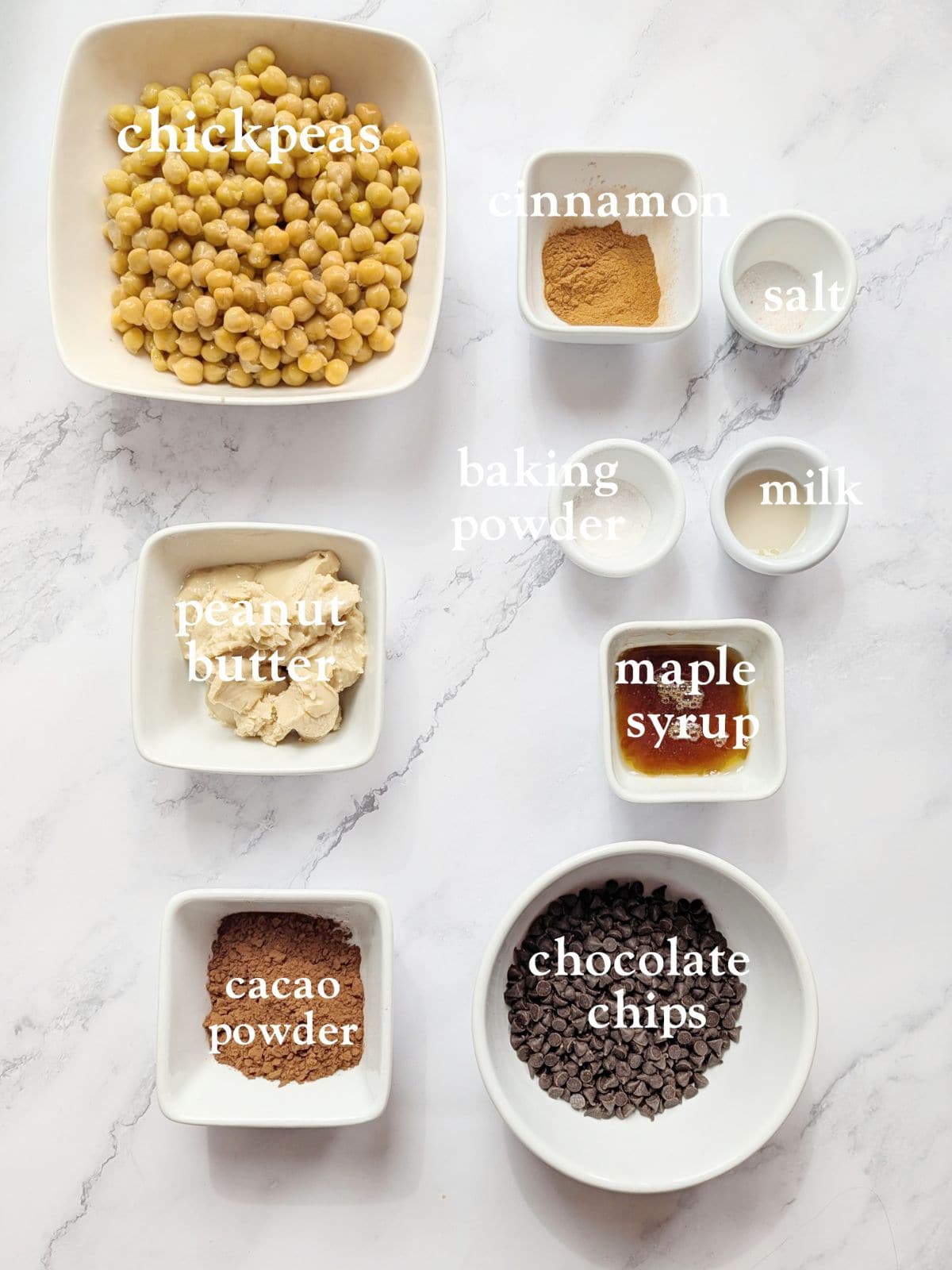 Flourless chocolate chickpea cookie ingredients on a mable surface.
